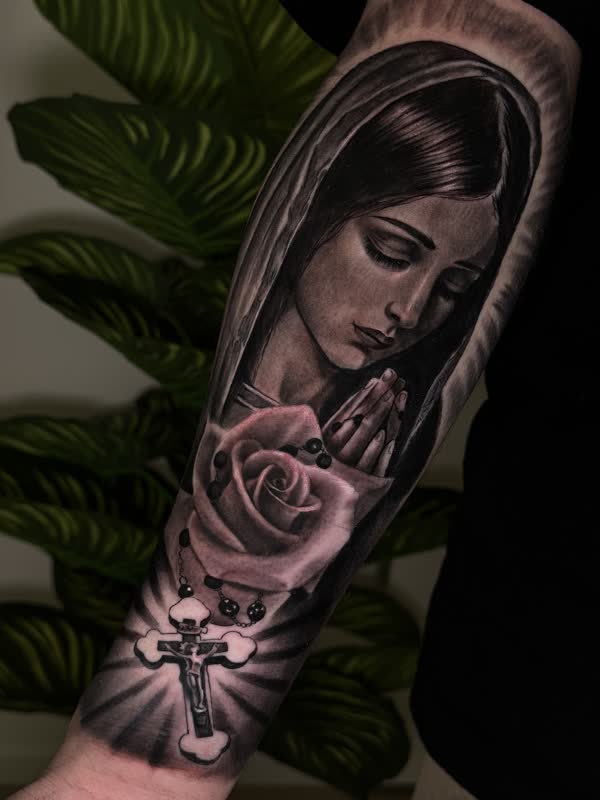Virgin Mary in prayer with a rose, black and grey forearm piece