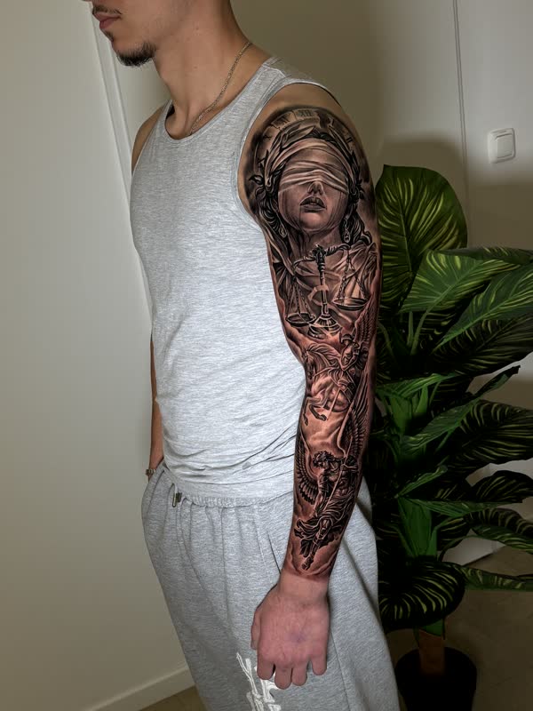 Full sleeve with Lady Justice holding scales and an angel warrior below