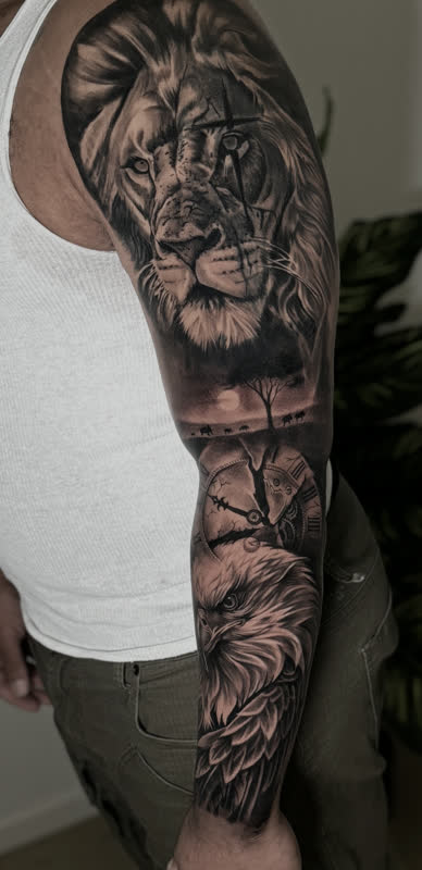 Full sleeve of a lion, dead tree and eagle in black and grey realism