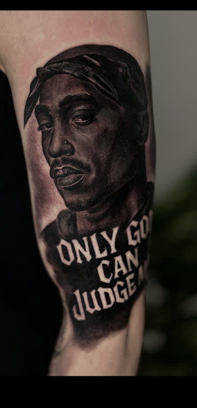 Tupac portrait tattoo with 'Only God Can Judge' lettering