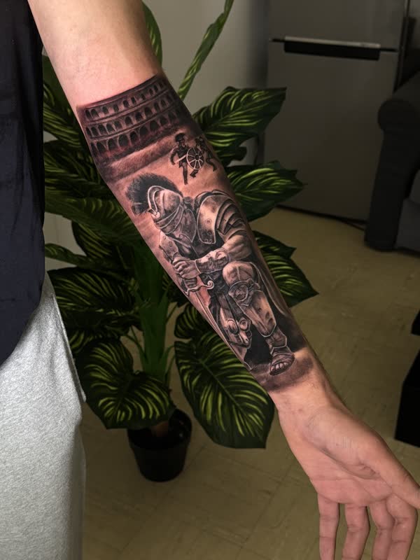 Forearm piece with the Roman Colosseum, a seated soldier and ornamental linework